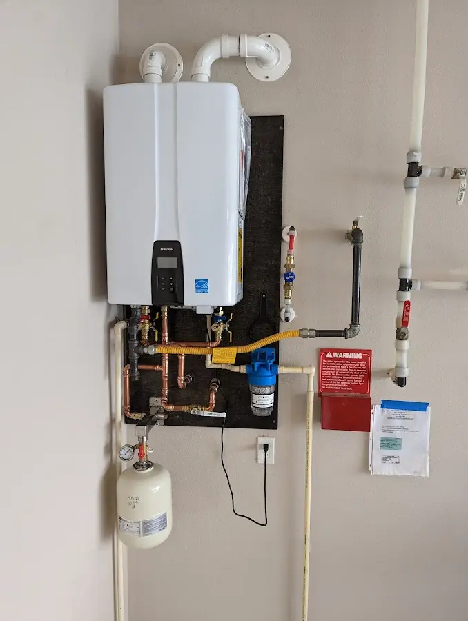 Professional plumber installing copper piping in a Willowbrook home